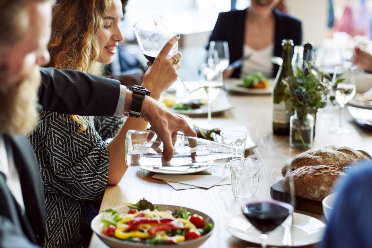 Picture of people dining on a long dining table